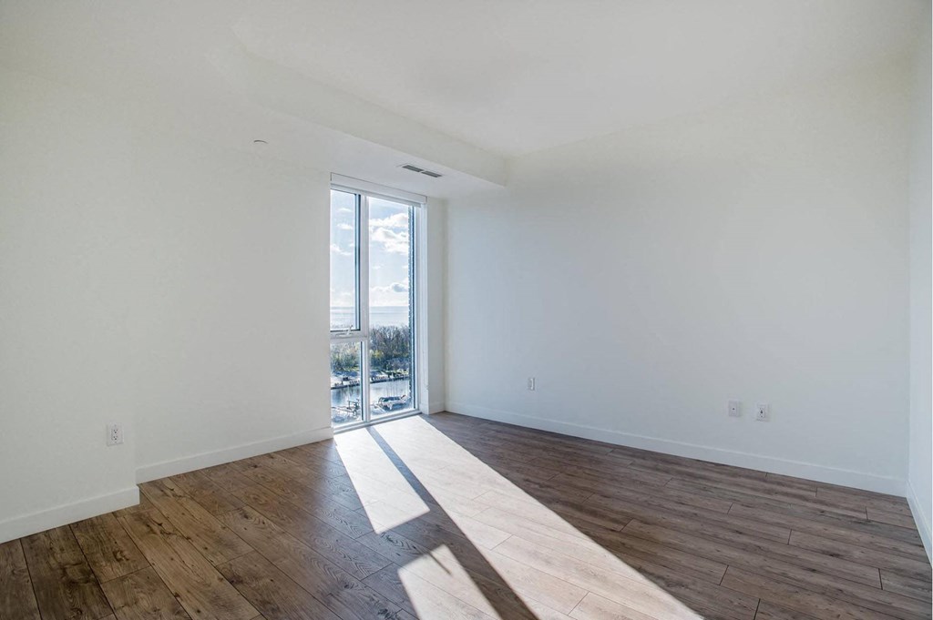 a living room with white walls and a sliding glass door