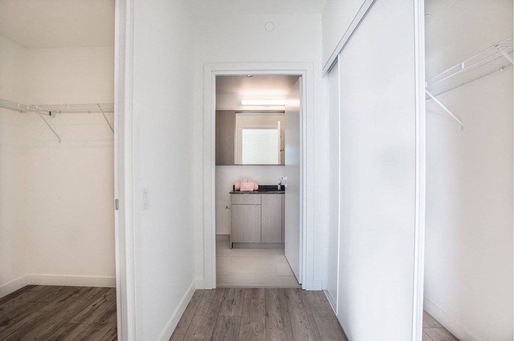a renovated living room with a hallway to a kitchen