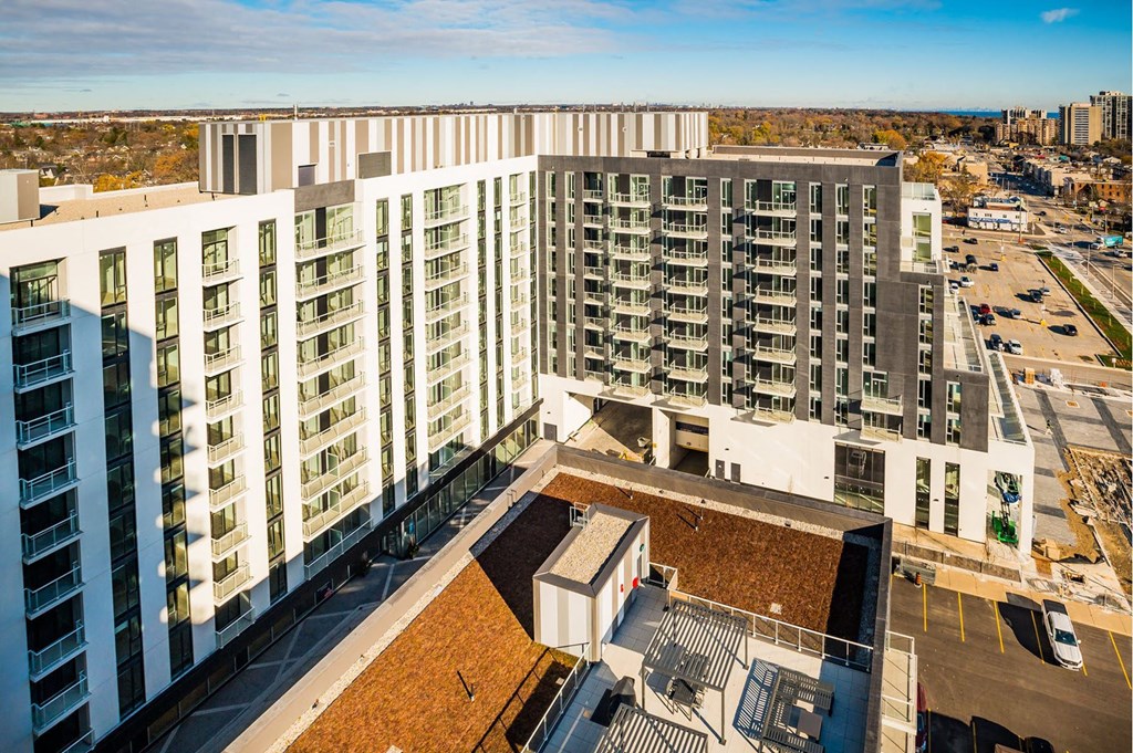 an aerial view of an apartment complex with a city in the background