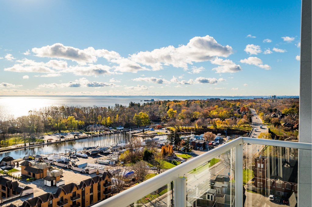 a balcony with a view of a city and a body of water