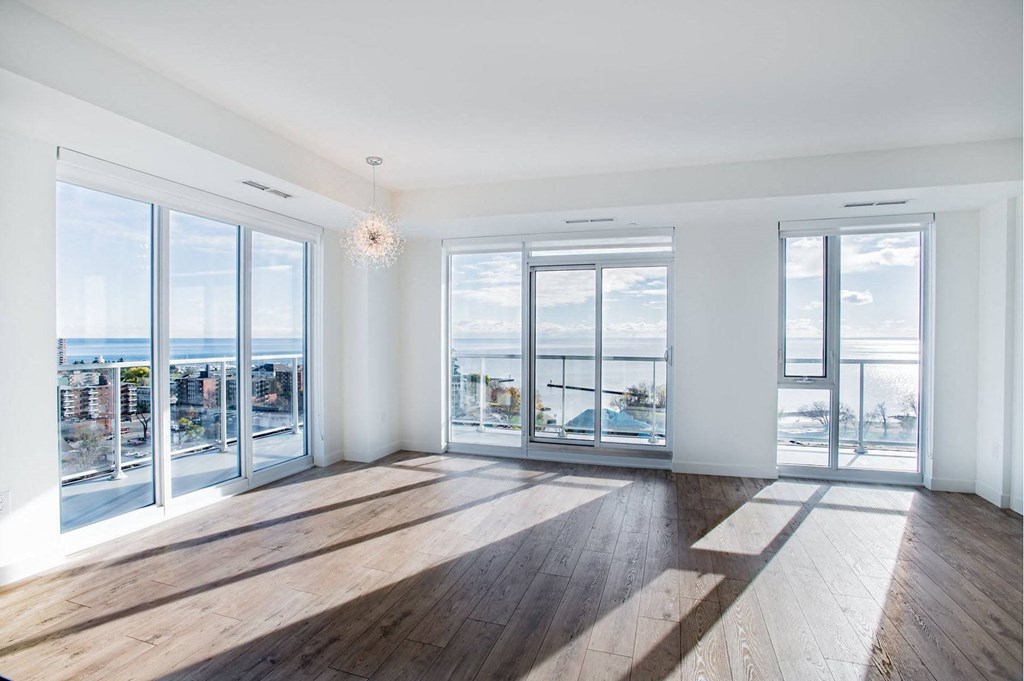 a living room with glass doors and a view of the ocean