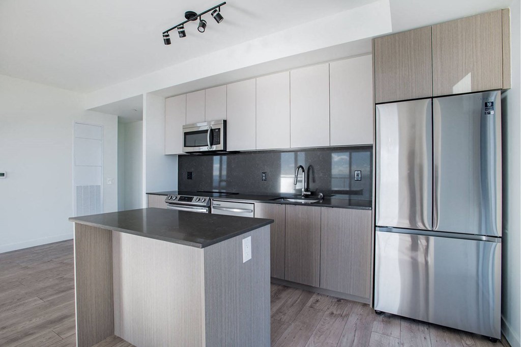 a modern kitchen with stainless steel appliances and a counter top
