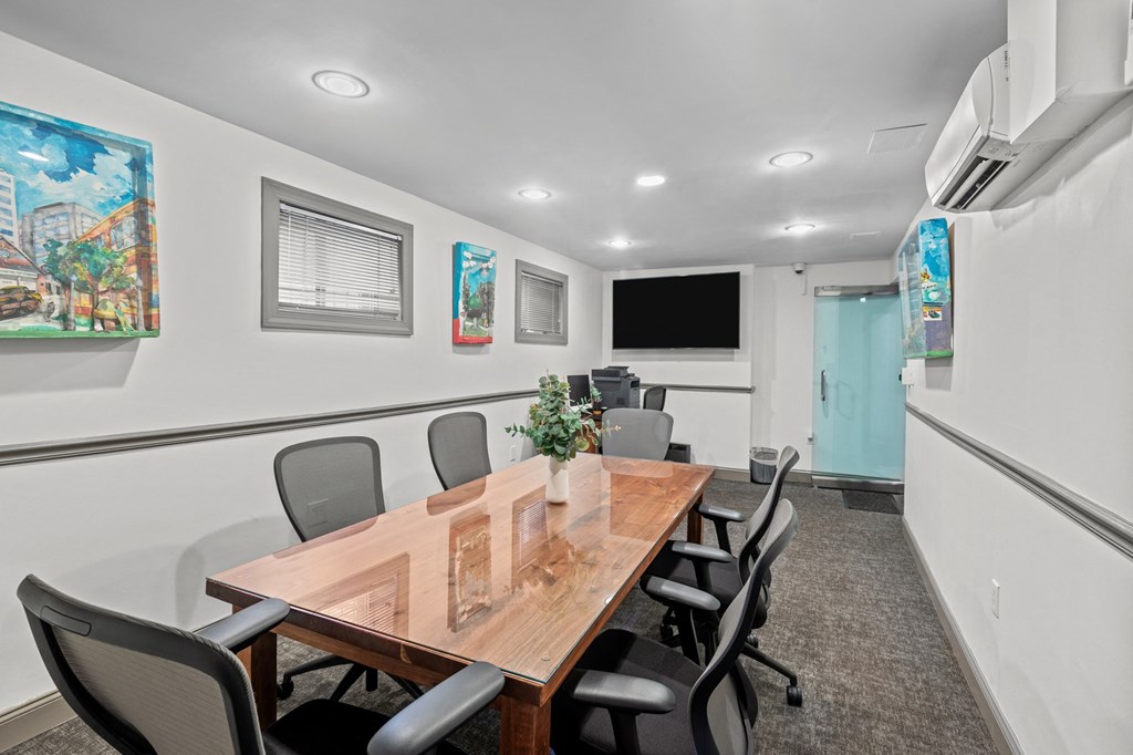 a conference room with a wooden table and chairs