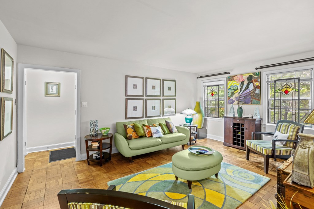 a living room with a green couch and a fireplace