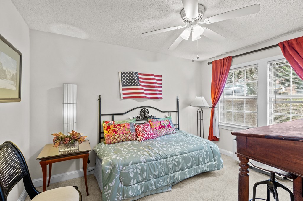 a bedroom with a bed and a large flag on the wall