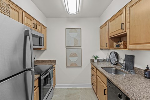 the kitchen of a modern apartment with stainless steel appliances and granite counter tops