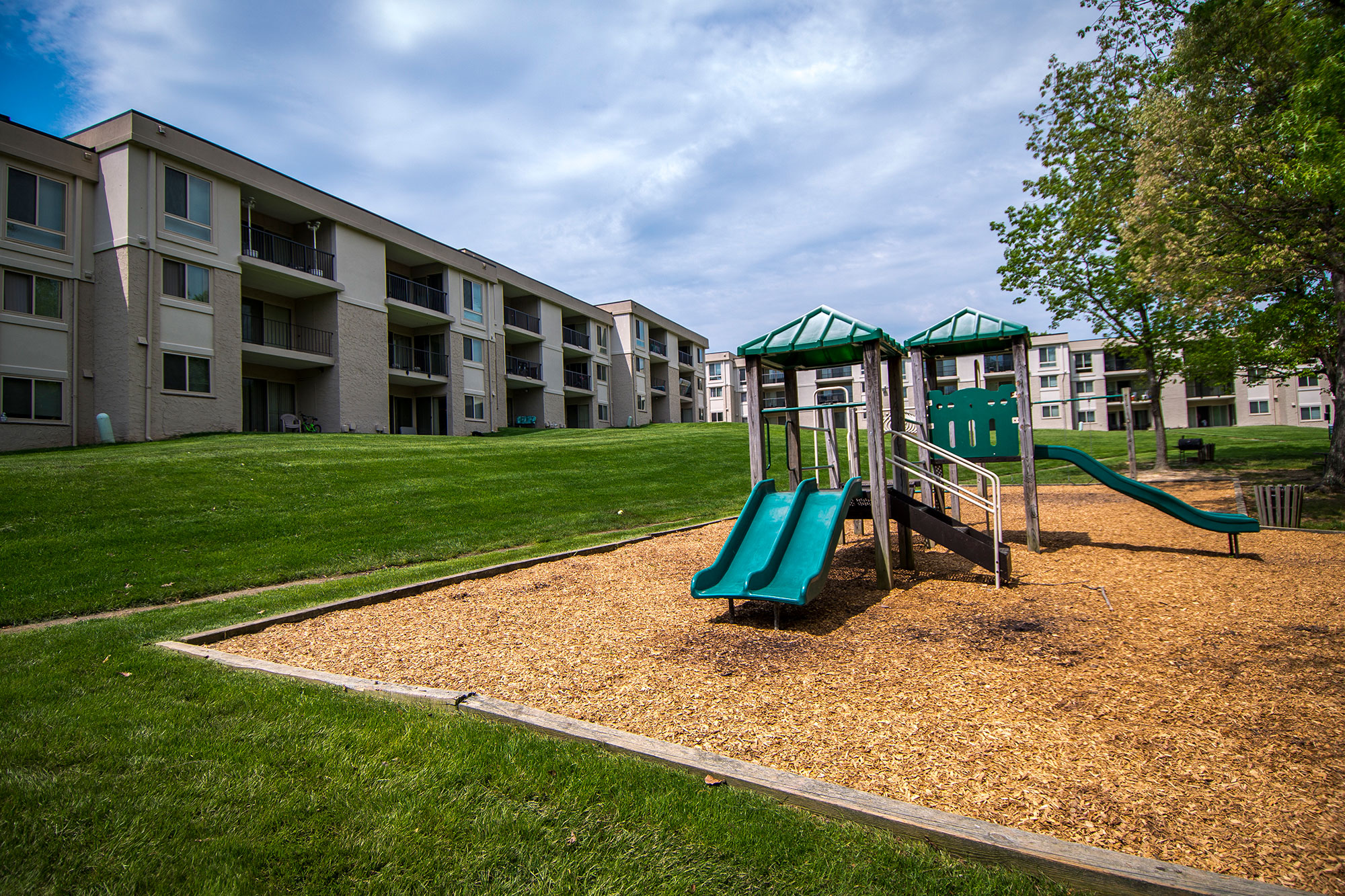 Ashley Apartments Wooded Playground Area Photo