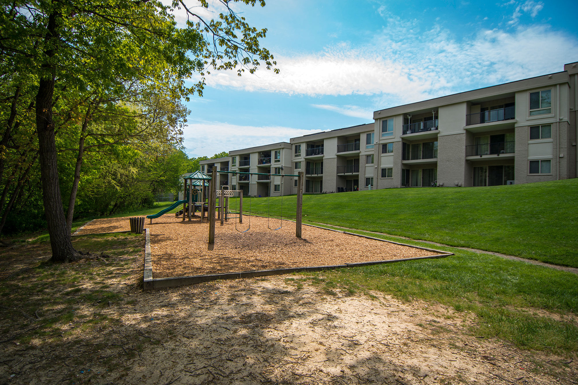 Ashley Apartments Wooded Playground Area Side Photo