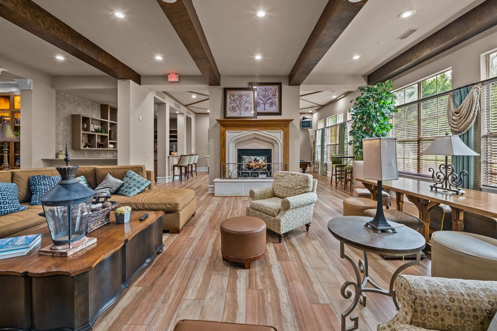 club house with couches and chairs and a fireplace