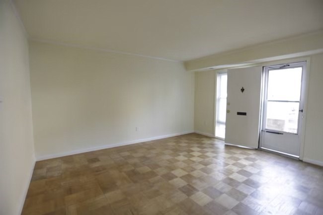 A room with a tiled floor and a door.at Normandy Hill Apartments, Alexandria Virginia