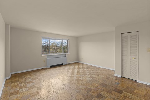 A room with a brown tiled floor and a window.at Kensington House, Kensington Maryland