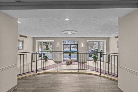 A balcony with a black railing and a view of the street below.at Kensington House, Kensington