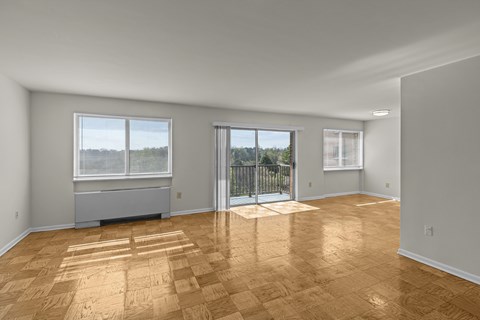 A room with wooden flooring and a sliding glass door.at Kensington House, Maryland, 20895