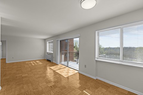 A room with a sliding glass door leading to a balcony.at Kensington House, Maryland, 20895