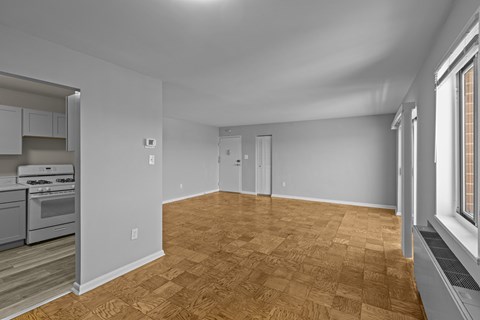 A room with wooden flooring and white walls.at Kensington House, Kensington, MD 20895 