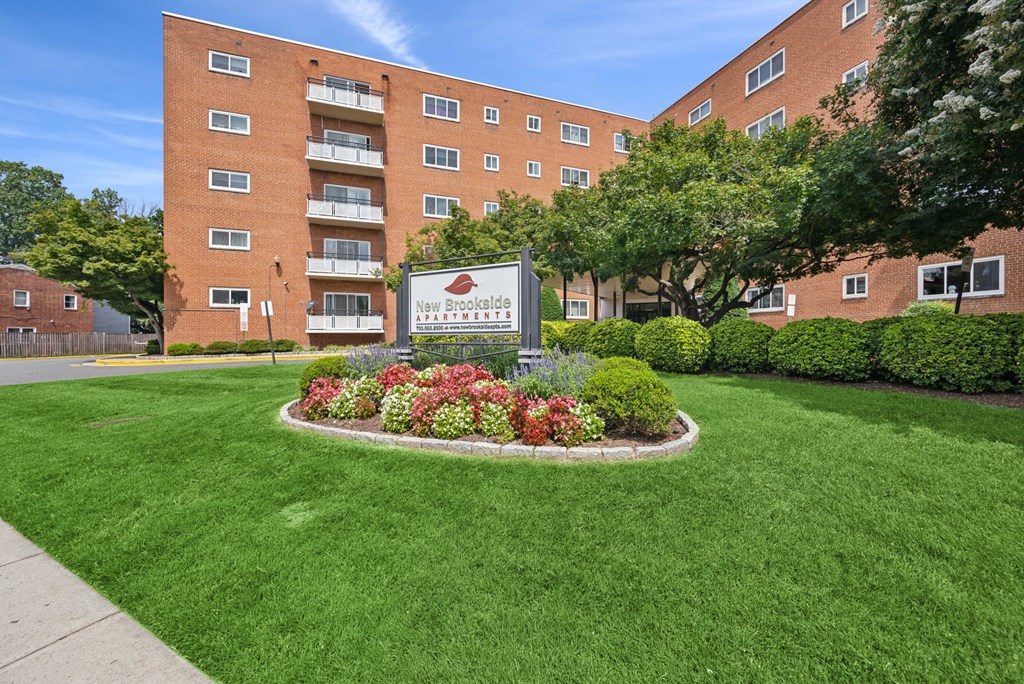 A large brick building with a sign in front of it.