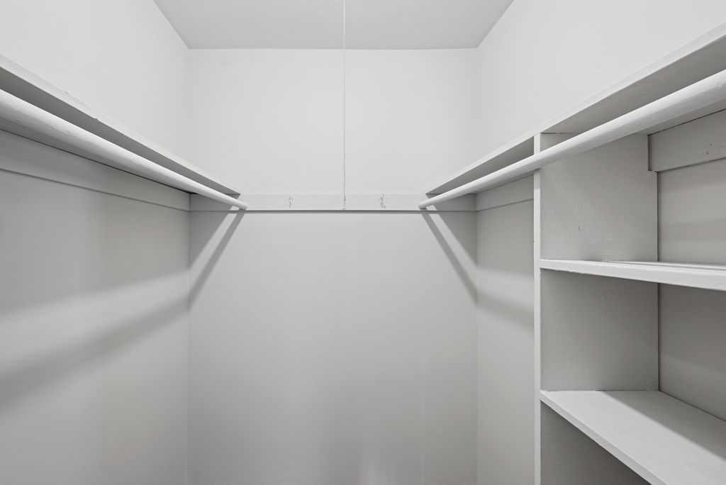 Empty white shelves in a room.