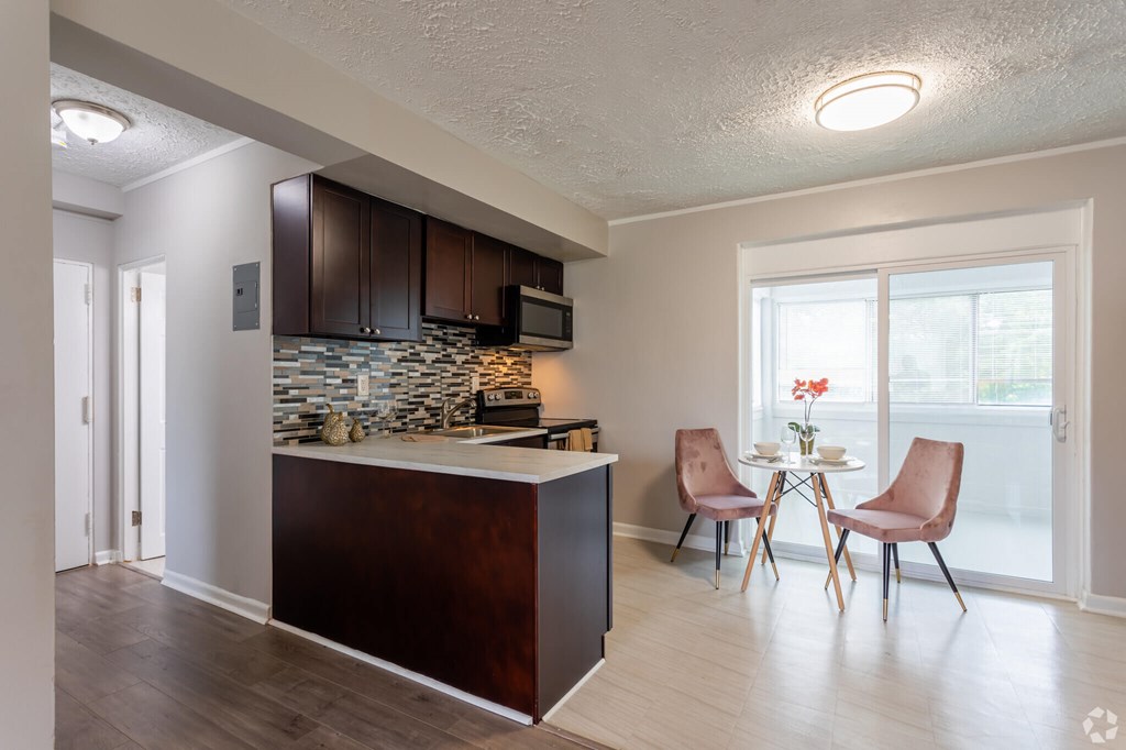 A kitchen with brown cabinets and a white countertop.at Greenbelt Properties, Greenbelt Maryland