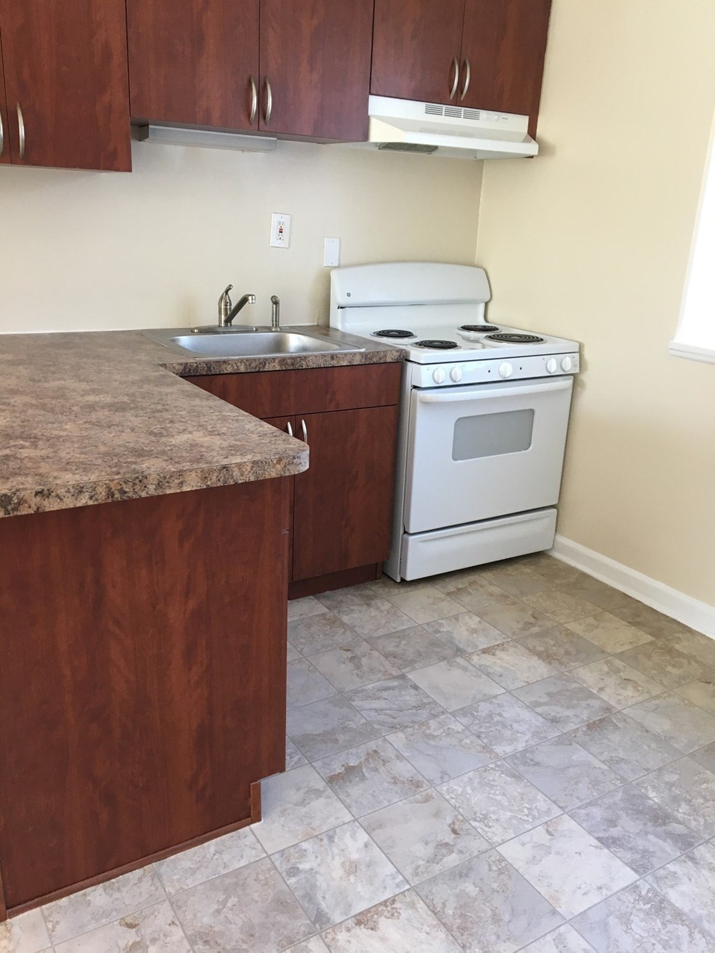 A kitchen with a white stove and a granite counter.at Greenbelt Properties, Maryland