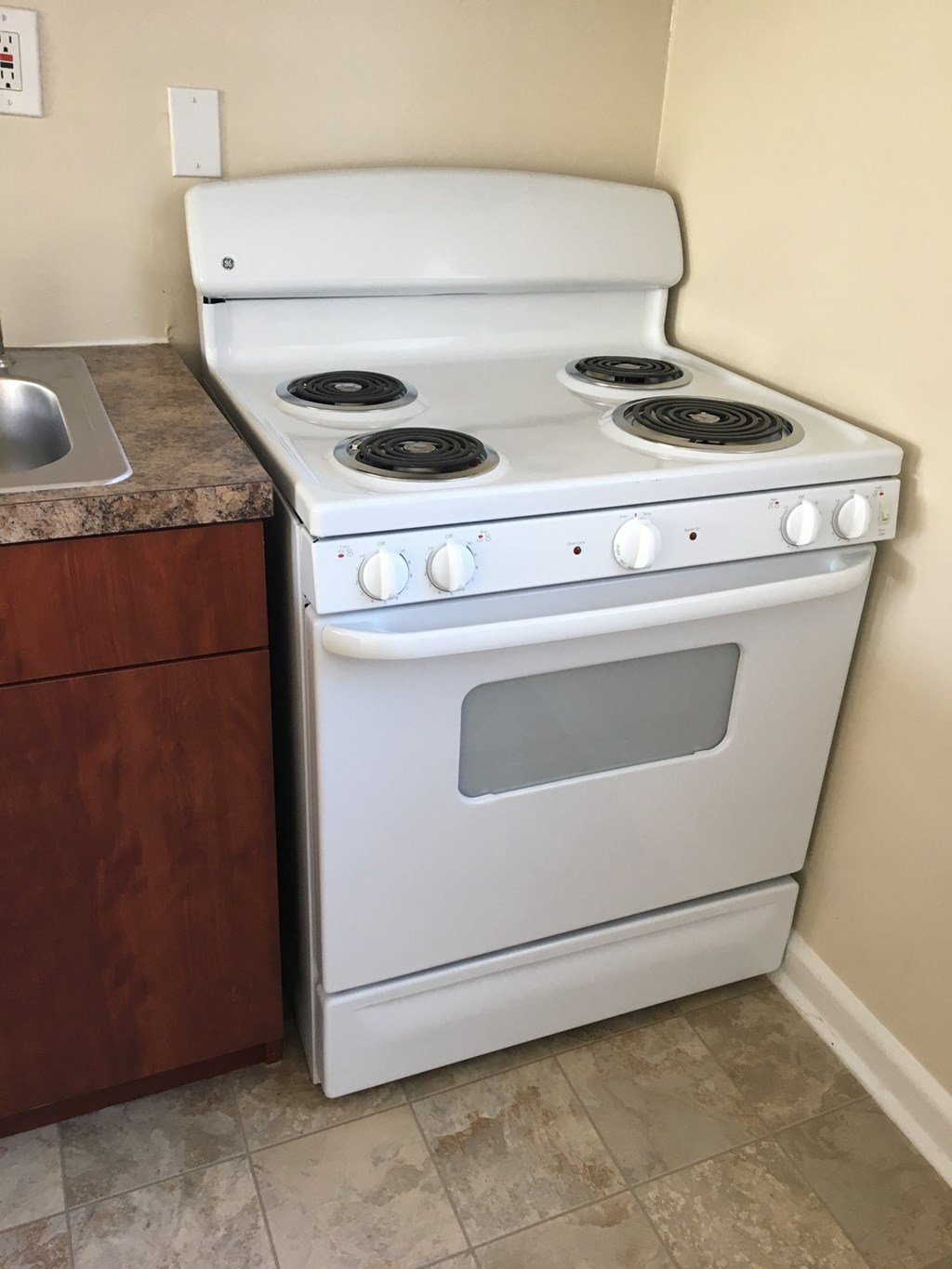 A white stove with a sink next to it.at Greenbelt Properties, Greenbelt