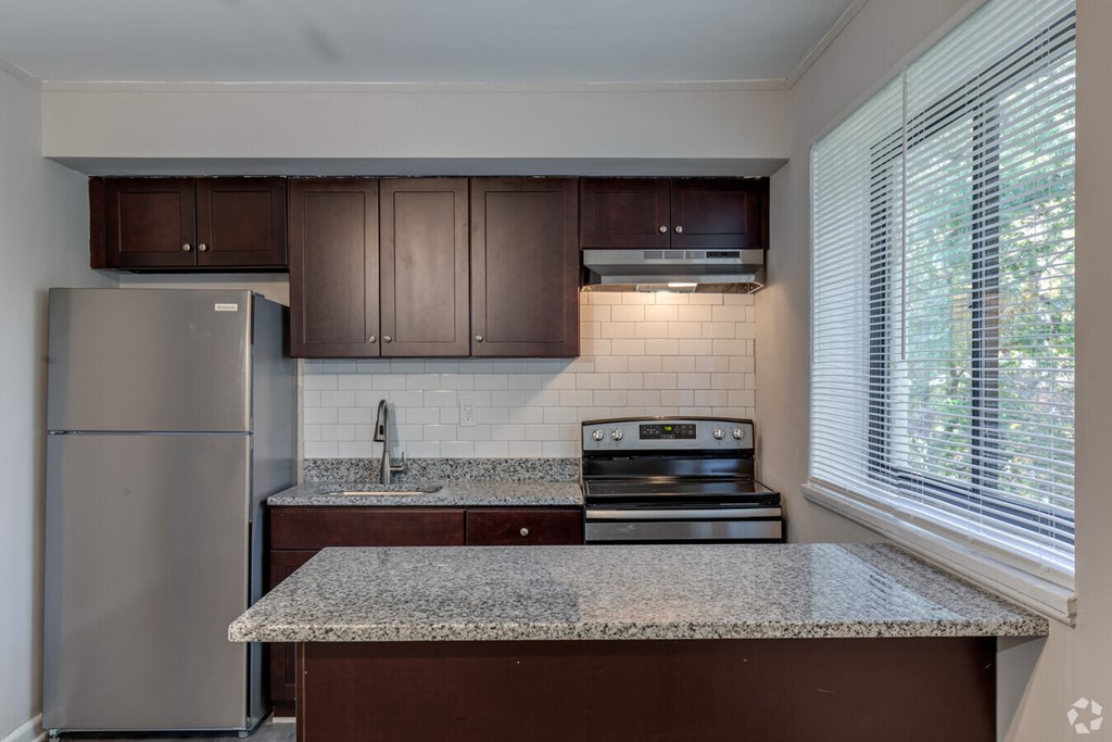 A kitchen with a granite countertop and stainless steel appliances.at Greenbelt Properties, Greenbelt