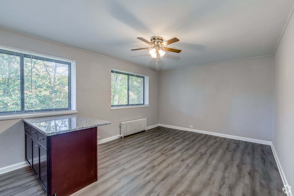 A room with a ceiling fan and a window overlooking trees.at Greenbelt Properties, Maryland, 20770