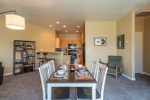 A dining room with a table set for two.