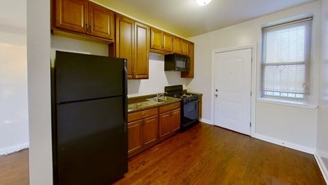 a kitchen with black appliances and wooden cabinets