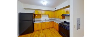 a kitchen with wooden cabinets and black appliances