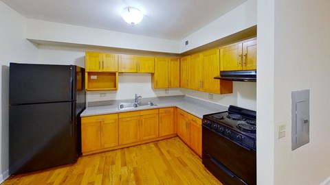 a kitchen with wooden cabinets and black appliances