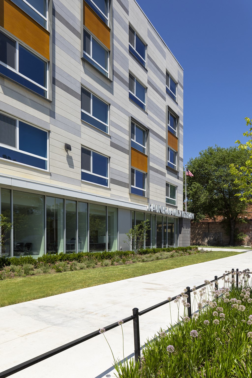 the facade of a building with a sidewalk in front of it