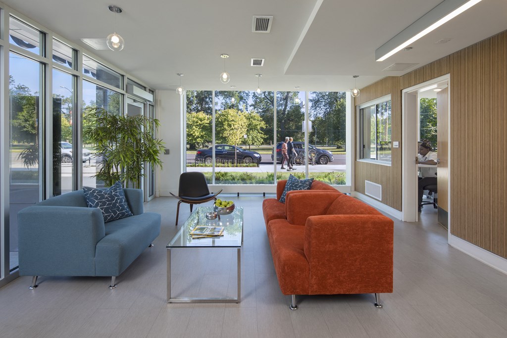 a living room with couches and a coffee table in front of a large window