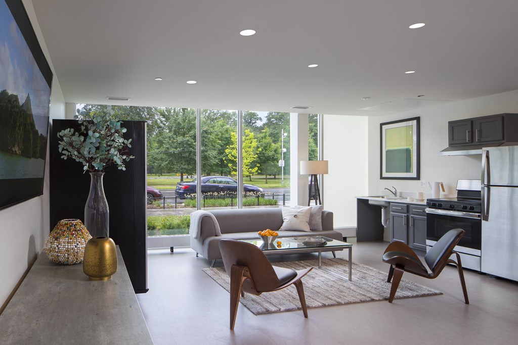 a living room with a couch and a table in front of a window