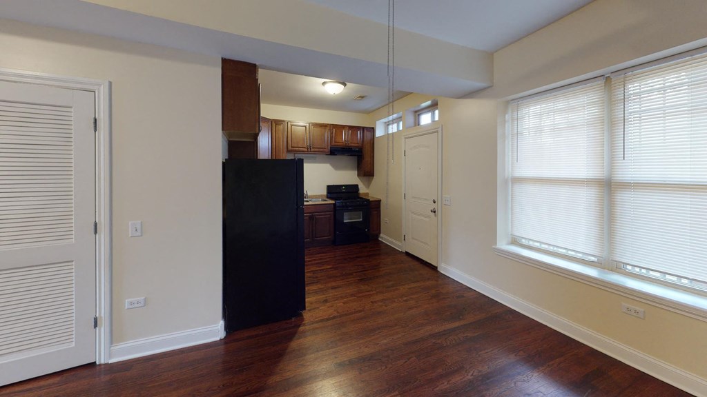 a kitchen with a hard wood floor and a large window