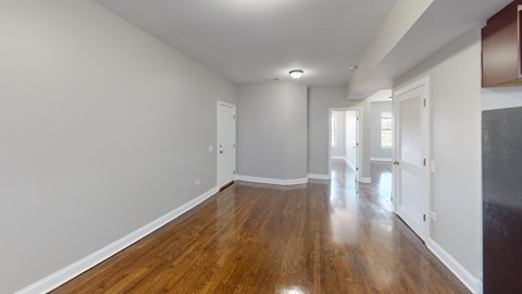A room with wooden floors and white walls.