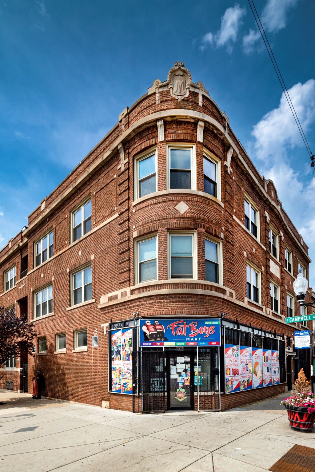 a brick building with a store on the corner of a street