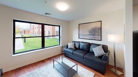 a living room with a couch and a large window