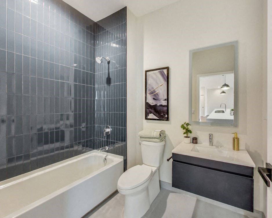 a bathroom with a toilet and a tub and a sink