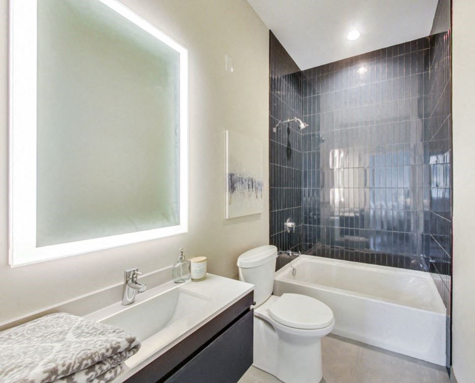 a bathroom with a toilet and a tub and a sink