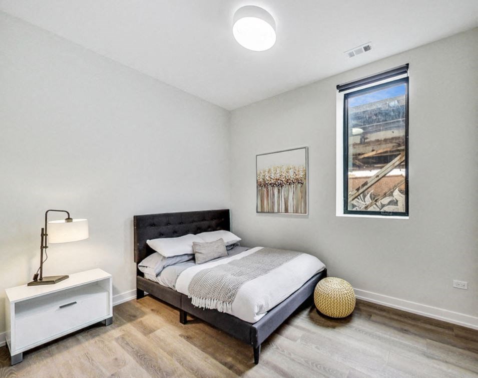 a bedroom with a bed and a window