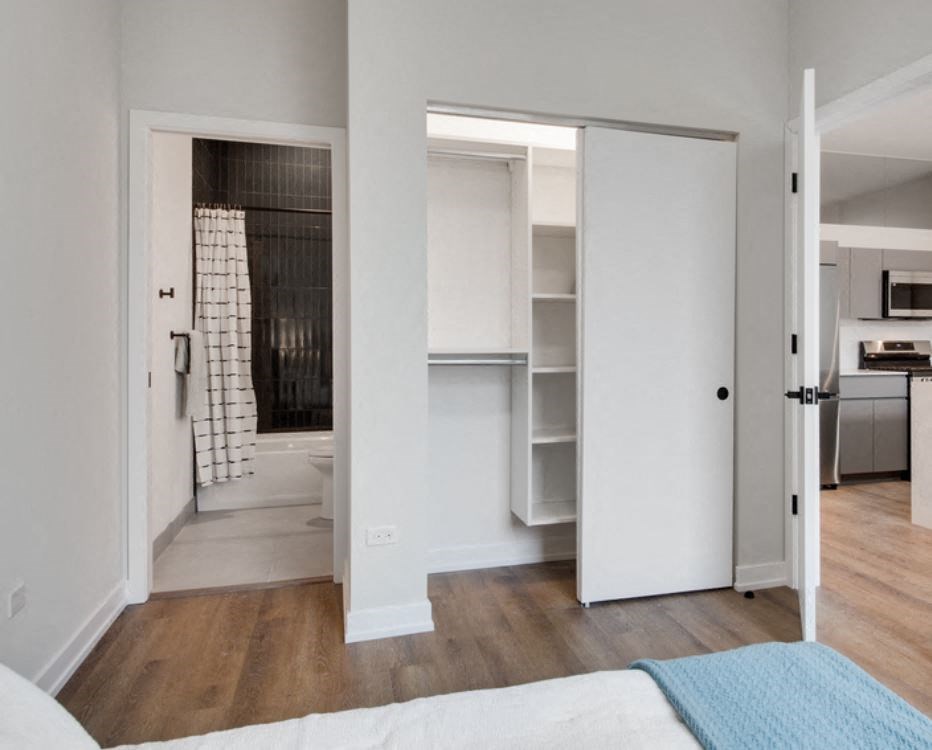 a bedroom with a bed and a closet