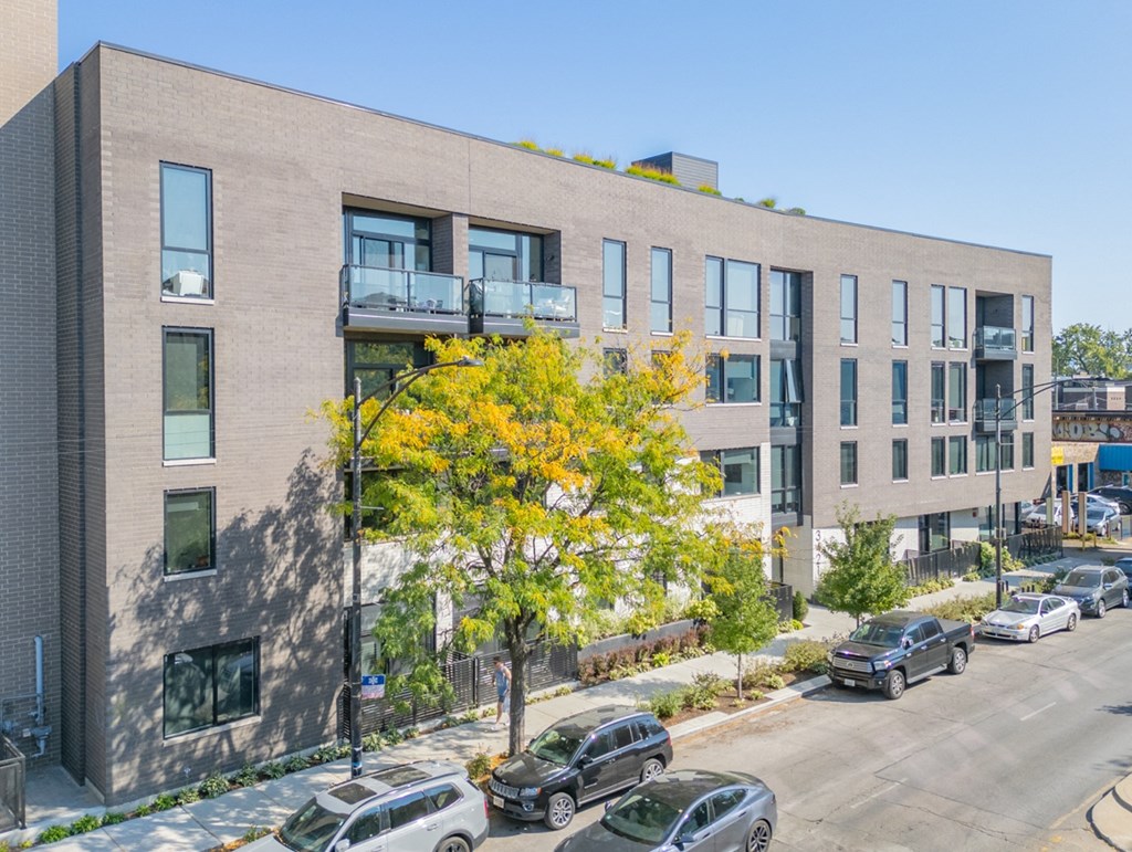 a large brick building with cars parked in front of it