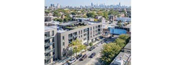 an aerial view of a building with a city in the background
