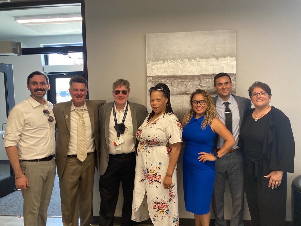 a group of people posing for a picture in an office