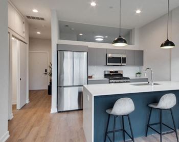 a kitchen with a counter top and a refrigerator