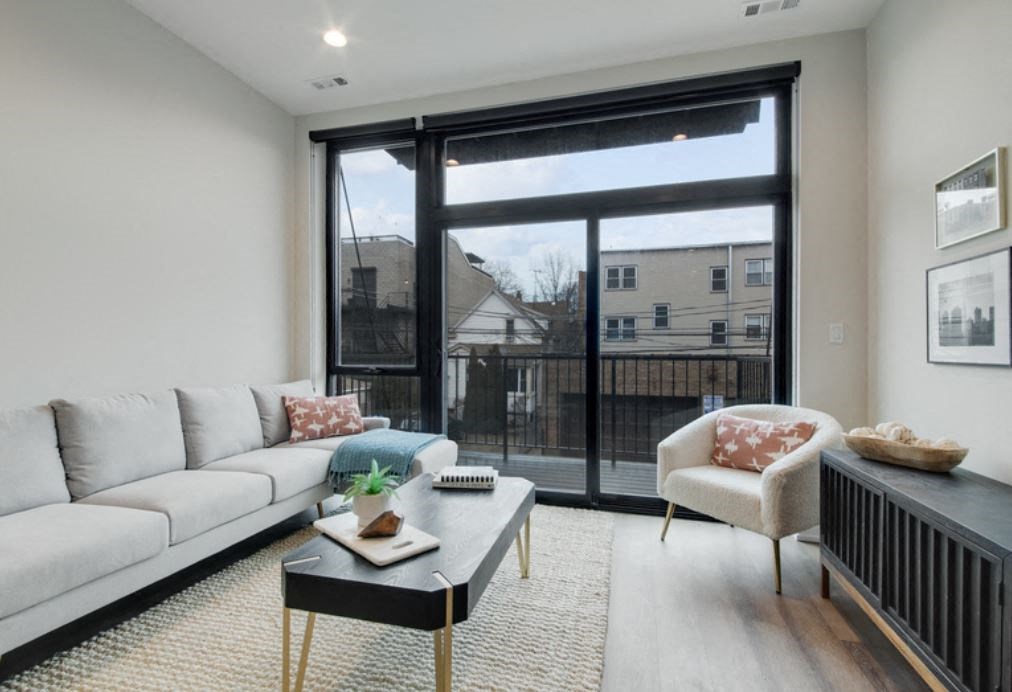 a living room with a large window and a couch and a table
