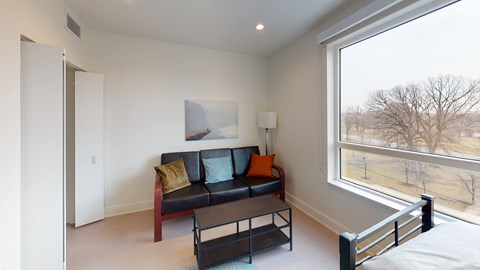 a living room with a couch and a large window