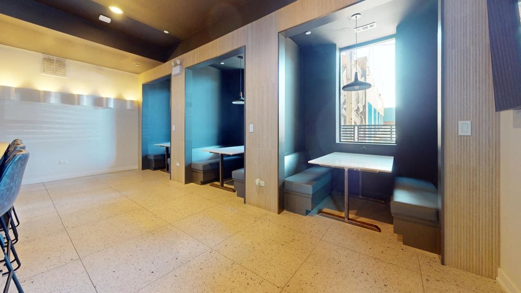a public restroom with tables and benches and a blue wall
