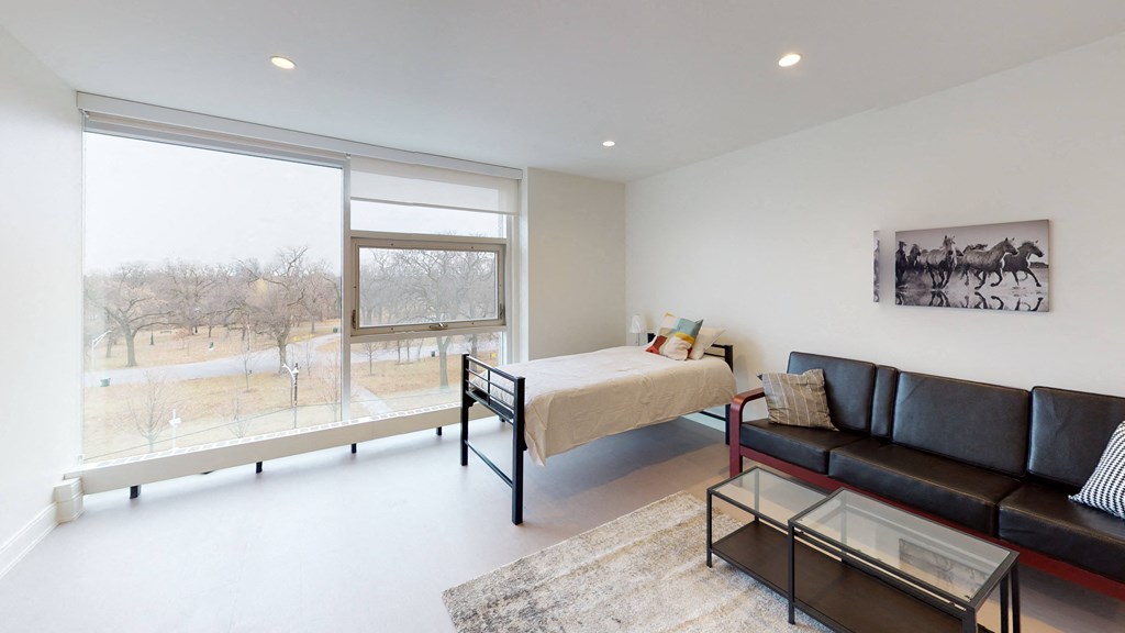 a bedroom with a bed and a large window