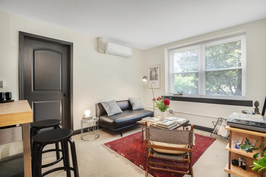 a living room with a couch and a coffee table and a window